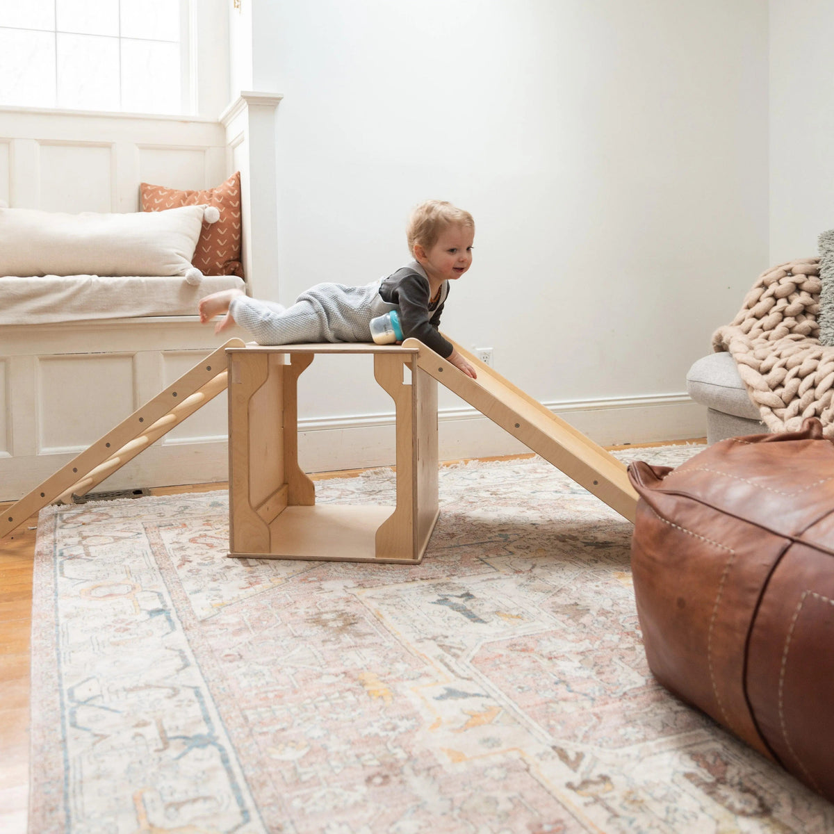 Toddler climbing a Fern Kids indoor play structure